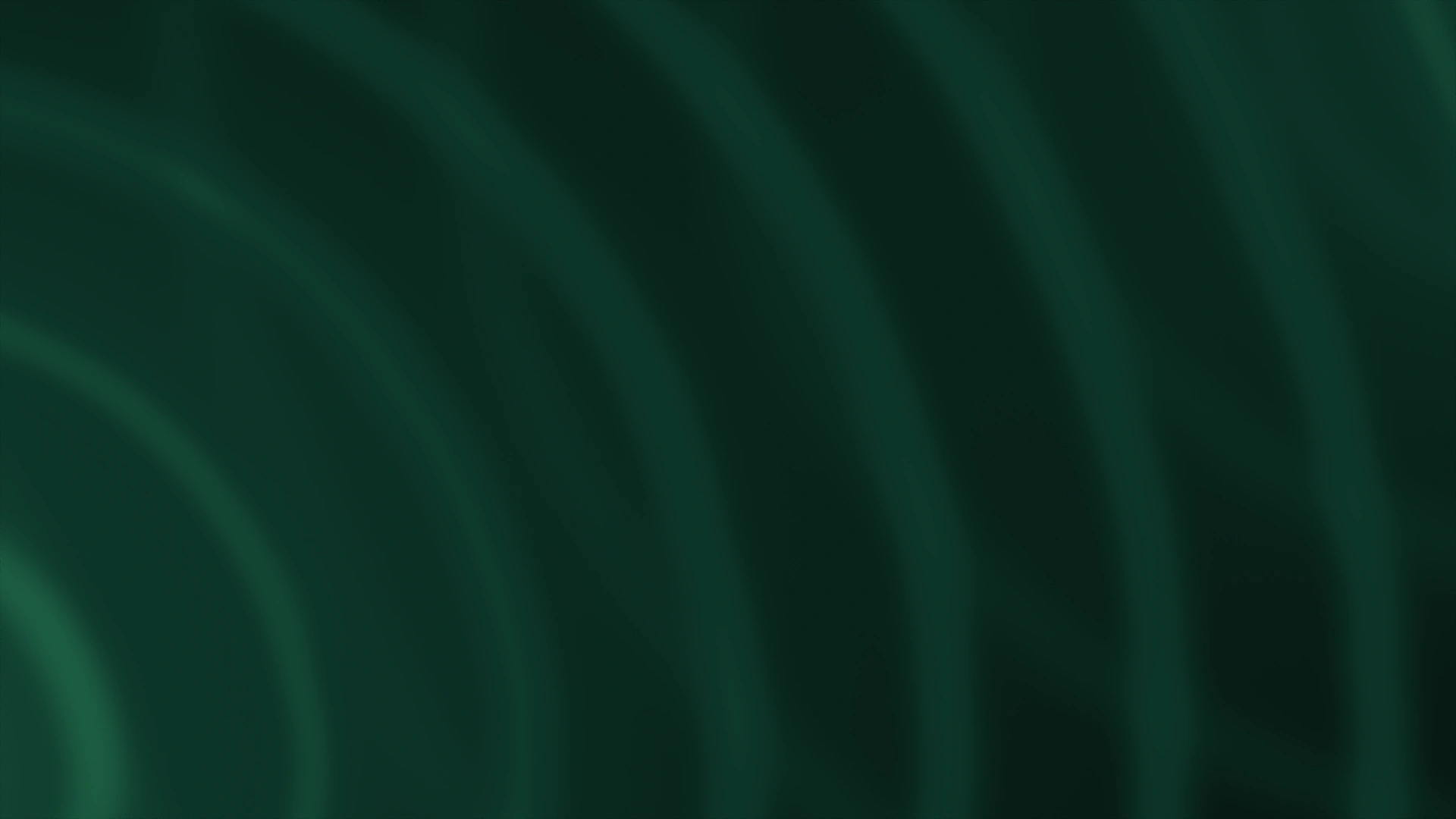 Emerald and forest-green light against a dark charcoal background